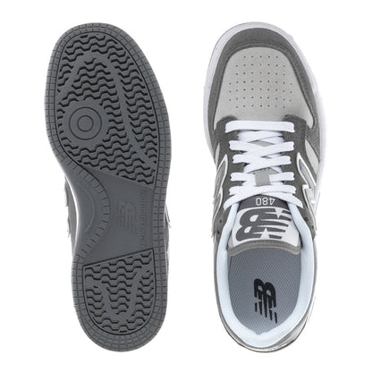 Youth New Balance sneaker view: textured rubber outsole tread and gray heel collar with laces