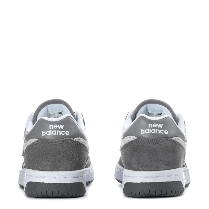 Youth New Balance sneakers with heel branding, dark gray suede, white midsole, black rubber tread