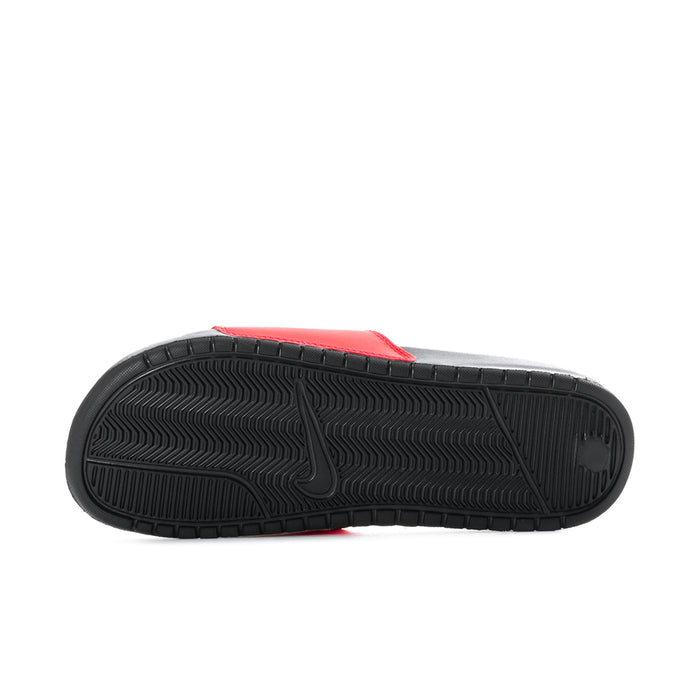 Outsole view of red slide sandals with black tread pattern