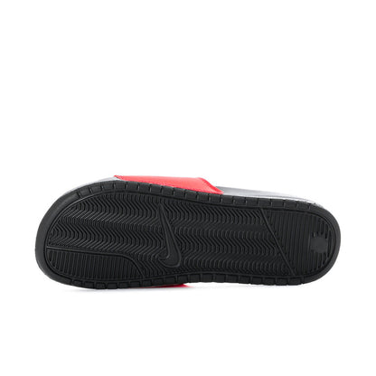 Outsole view of red slide sandals with black tread pattern