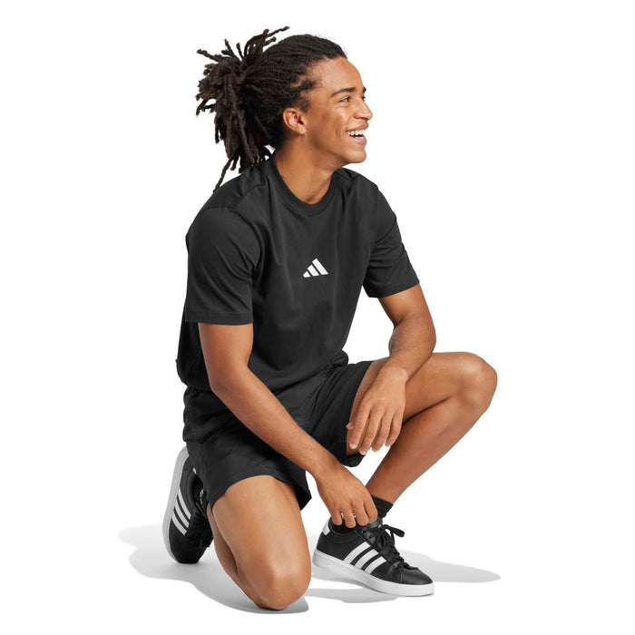 Men's black crewneck t-shirt with small white adidas logo; side profile