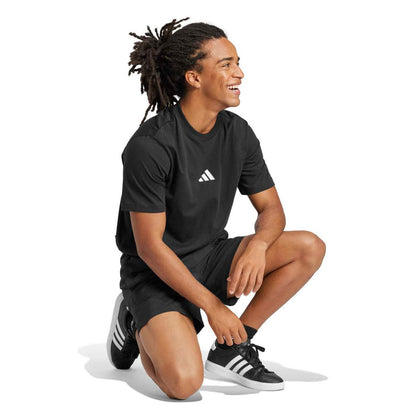 Men's black crewneck t-shirt with small white adidas logo; side profile
