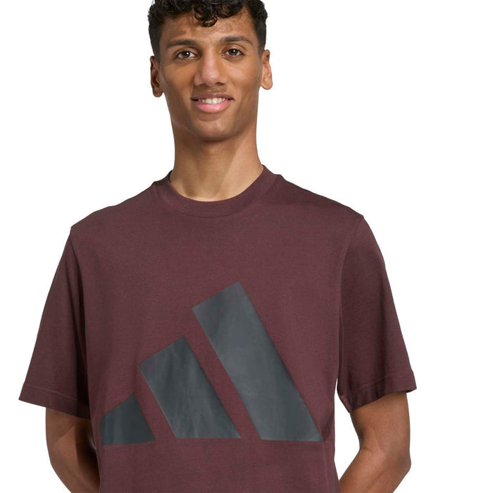 Men's brown crew-neck T-shirt with large blue-gray logo print, close-up