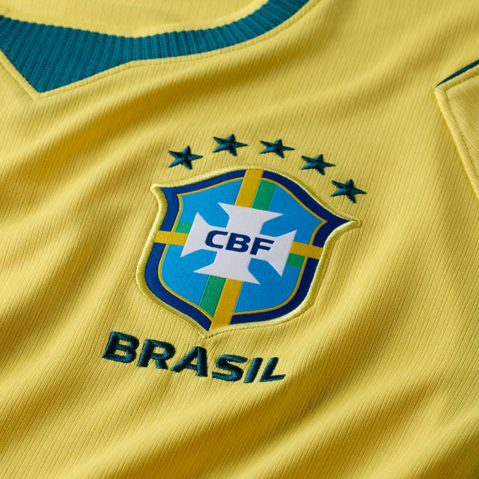Yellow jersey fabric with teal CBF crest and BRASIL lettering