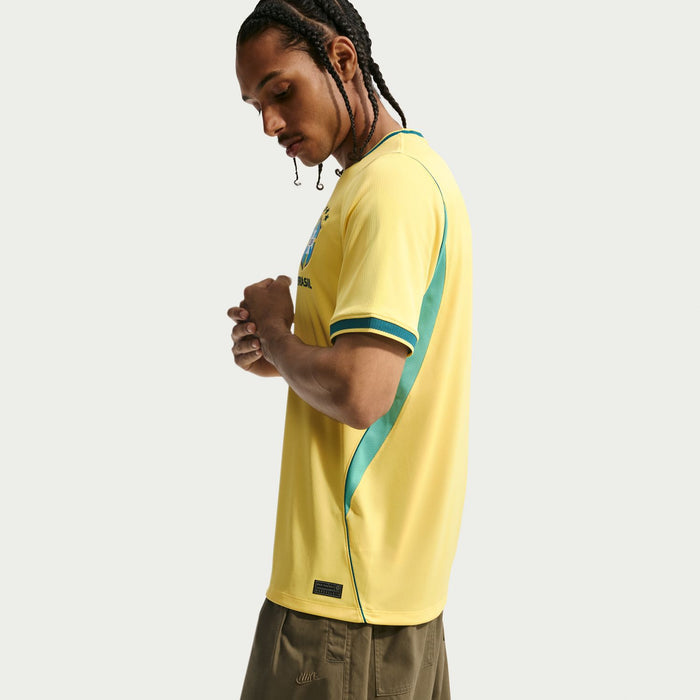 Yellow Brazil home jersey with teal sleeve stripes and side seam