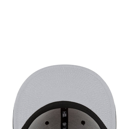 White baseball cap crown close-up with small ventilation eyelets