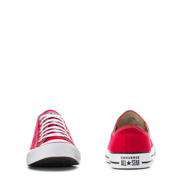 Pair of red Converse low-top sneakers with white laces and All Star heel patch