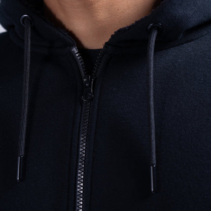 Black fleece hoodie zipper and hood drawstrings, close-up