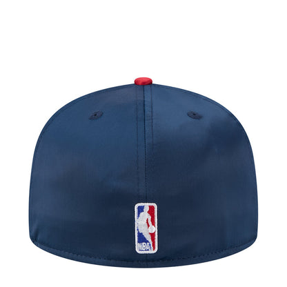 Two-tone satin baseball cap with rectangular NBA patch on navy crown and red snap