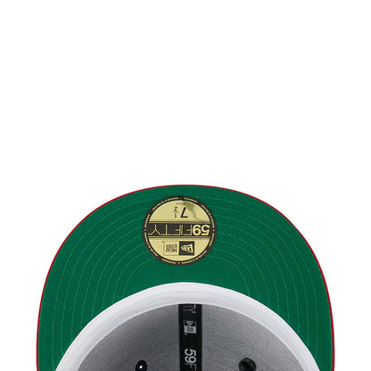 Green satin baseball cap top with circular label and stitched panel texture