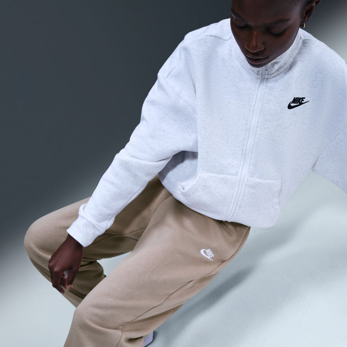 Women's fleece jogger pants in malt beige with side Nike logo and tapered cuffed hem