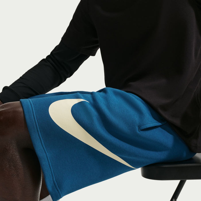Blue fleece shorts with large cream Nike swoosh on front leg panel