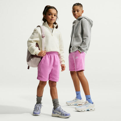 Light magenta youth sweat shorts on kids model, elastic waistband, Nike logo
