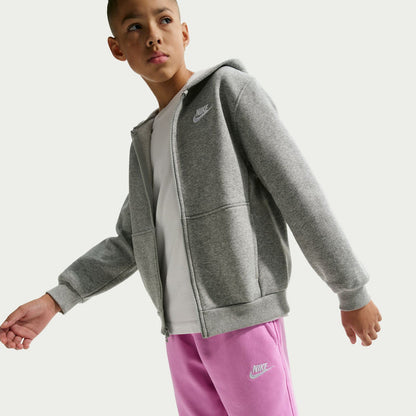 Youth light magenta sweat shorts with Nike logo, standing side view