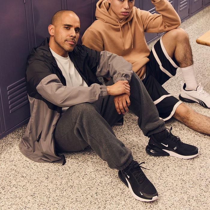 Mens hooded windbreaker, black and gray colorblock, worn by seated model