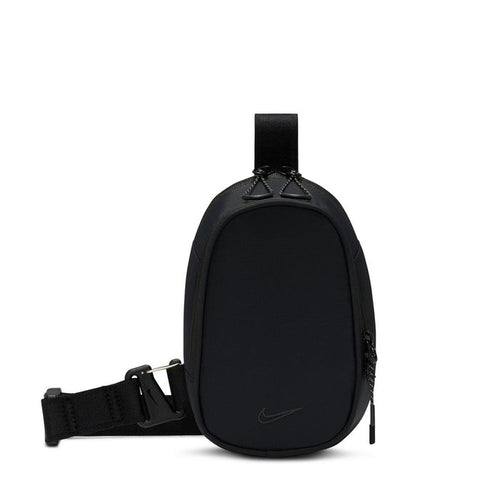 Black crossbody sling bag with adjustable strap, oval zip pocket, and swoosh logo