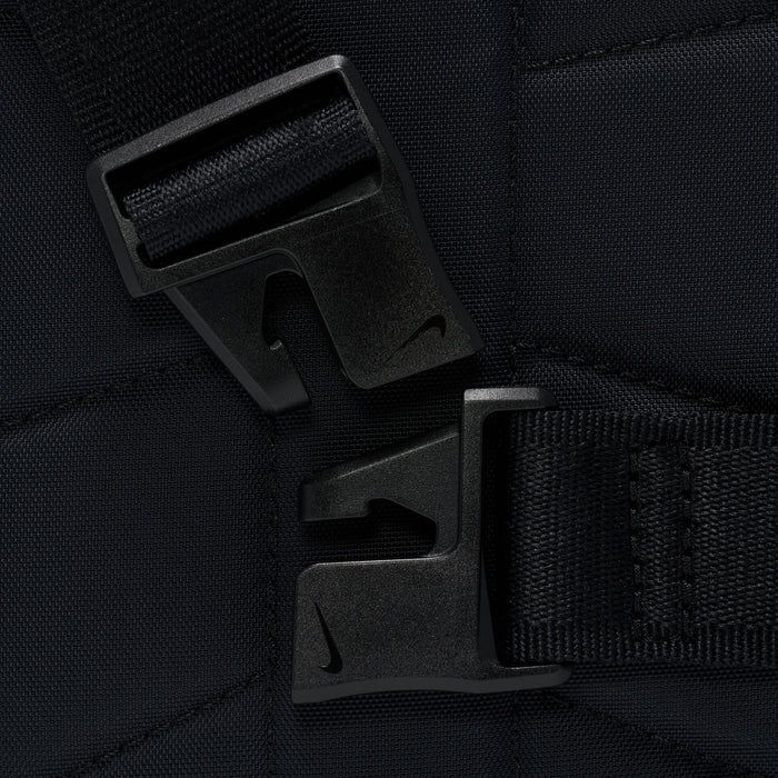 Closeup of black bag strap buckle and zipper pull hardware