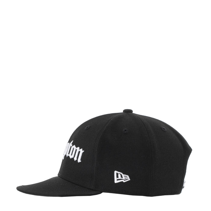 Black baseball cap with white embroidery and New Era flag patch at the front
