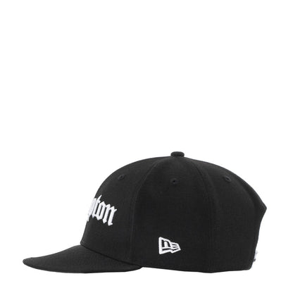 Black baseball cap with white embroidery and New Era flag patch at the front
