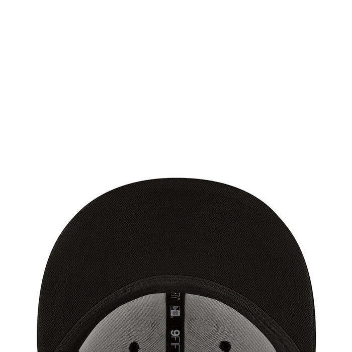 Black cap inner brim close-up with stitched brim edge and New Era label