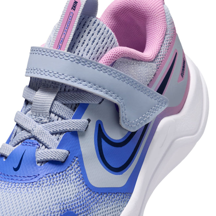 Kids running shoe upper close-up: light blue mesh, pink collar, strap, Nike swoosh.