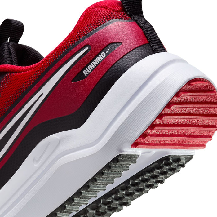 Close-up youth outsole and midsole with red traction pods and white cushioning