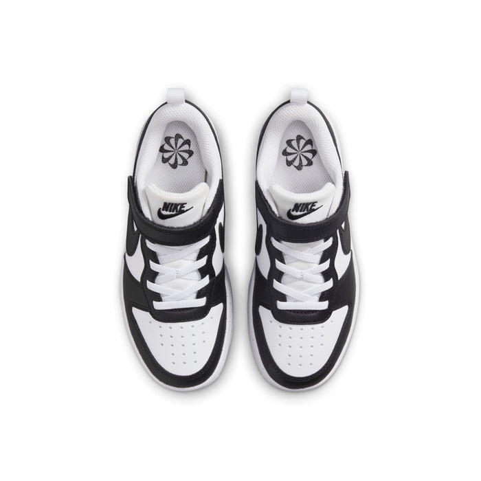 Kids sneakers top view in white with black accents, Nike logo on tongue and collar