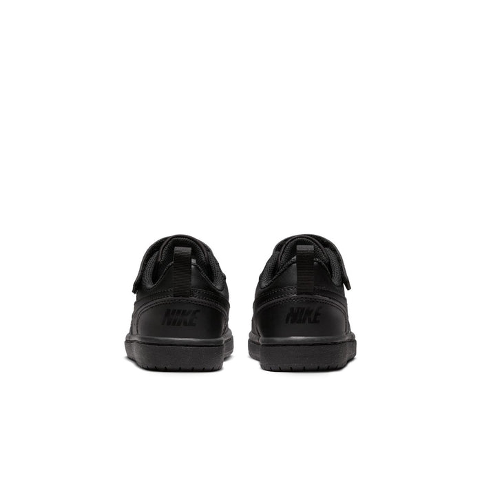 Kids black low-top sneakers, heel view, with Nike branding and loop tab