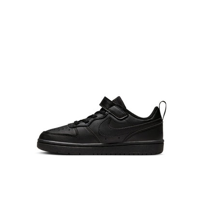 Kids black low-top sneakers, angled side view, with Velcro strap and laces