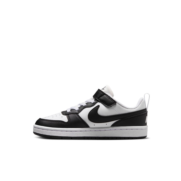 Kids low-top sneaker side view in white with black swoosh and hook-and-loop strap