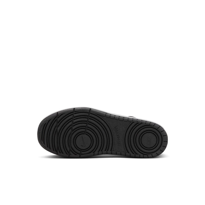 Black rubber outsole of kids low-top sneaker with circular traction pattern