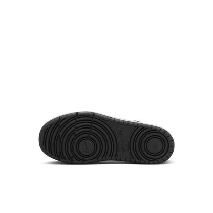 Black rubber outsole of kids low-top sneaker with circular traction pattern