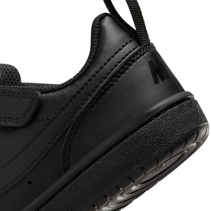 Black sneaker side close-up with swoosh logo and chunky textured sole