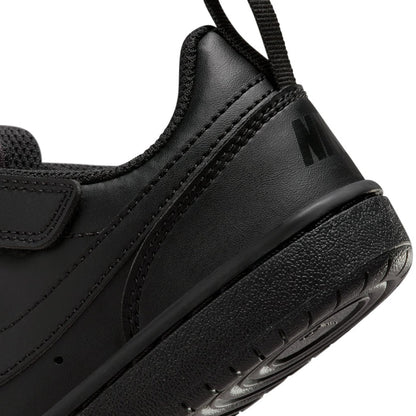 Black sneaker side close-up with swoosh logo and chunky textured sole