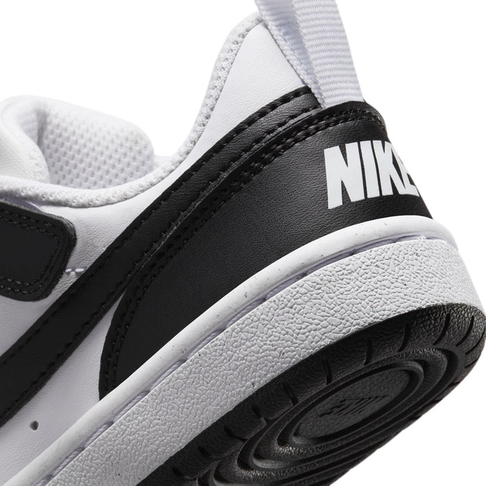 Kids sneaker heel close-up with NIKE text on black panel and textured rubber sole