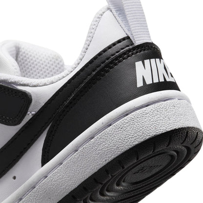 Kids sneaker heel close-up with NIKE text on black panel and textured rubber sole