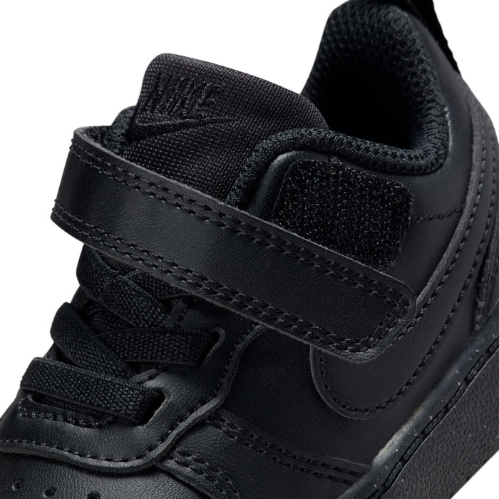 Toddler black sneaker upper close-up with strap, stitching, and mesh texture