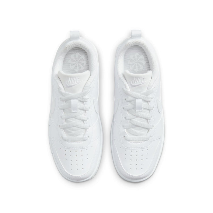 Youth white low-top sneakers, top view with perforated toe and Nike logo