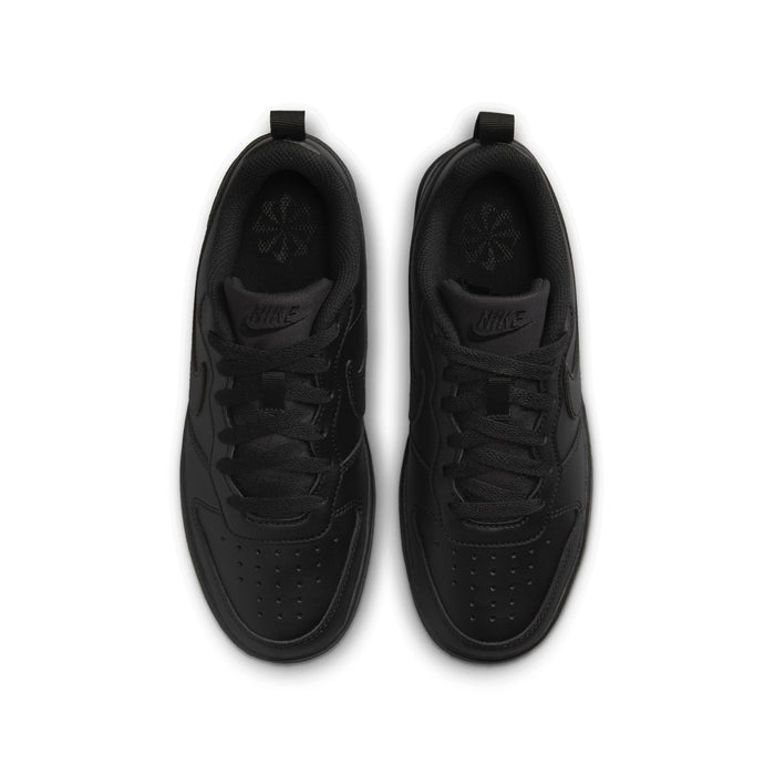 Pair of youth black sneakers from above, showing tongues and lace eyelets