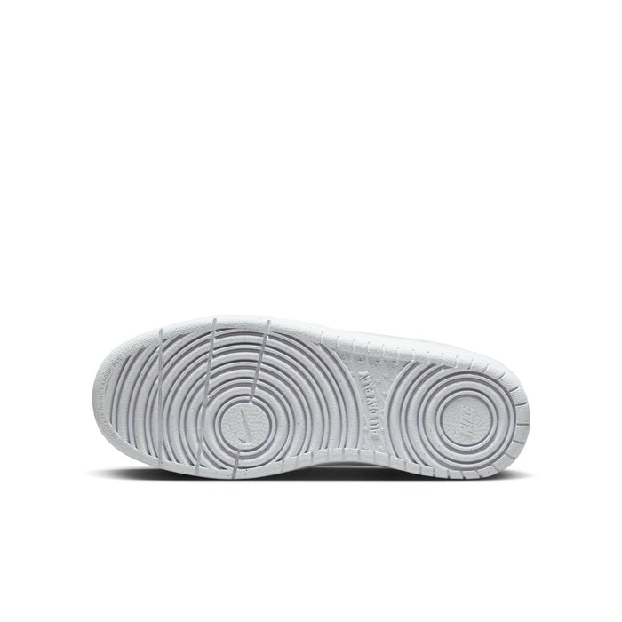 Youth white low-top sneaker outsole with circular traction pattern