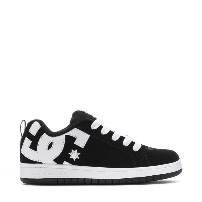 Youth black low-top sneakers with white laces, star patch, and DC side logo