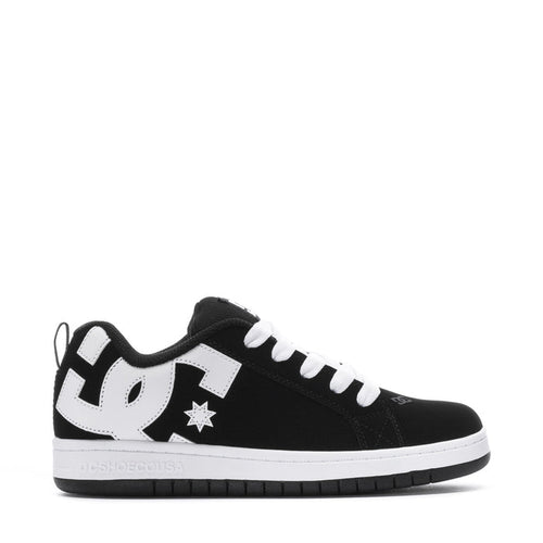 Youth black low-top sneakers with white laces, star patch, and DC side logo
