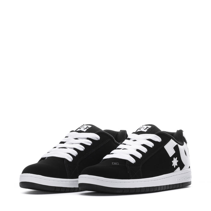 Youth black low-top sneakers with white laces, white tongue logo, and star detail