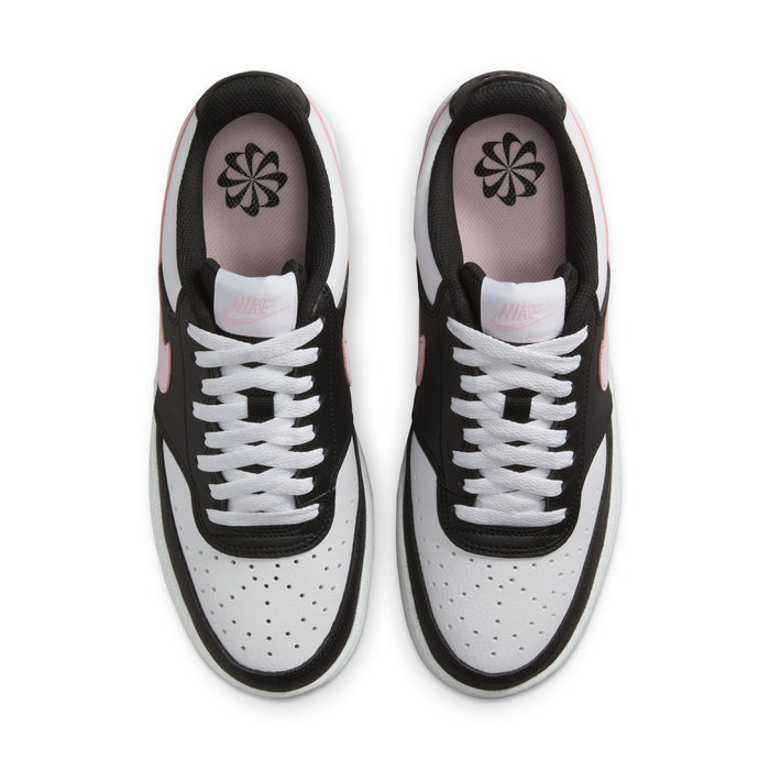 Low-top sneakers top view with perforated toe panels, white laces, flower logo on tongue