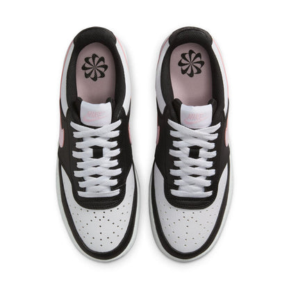 Low-top sneakers top view with perforated toe panels, white laces, flower logo on tongue