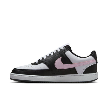Low-top sneaker side profile in black and white with pink swoosh and white laces