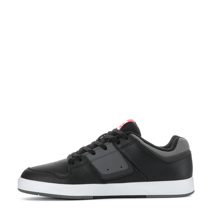 Men's black sneakers, side view with mesh panels and DC logo on quarter