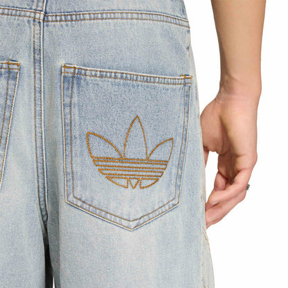 Light blue denim front pocket with tan trefoil embroidery and double-stitched edges.