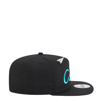 Black A-frame baseball cap, side view with teal lettering and small team logo patch
