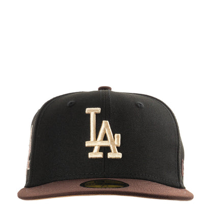 Two-tone black and brown baseball cap with raised LA logo on front